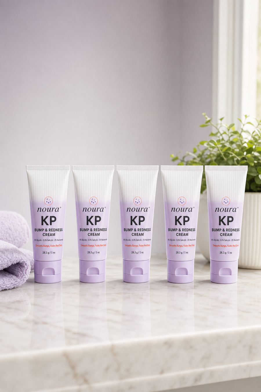 A smiling woman holding a tube of Noura KP Bump & Redness Cream