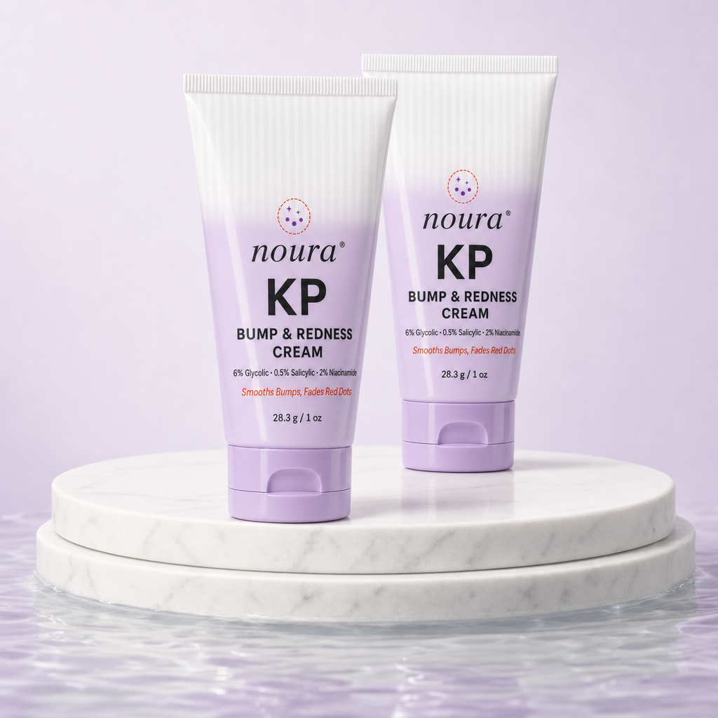 Two tubes of Noura KP Bump & Redness Cream on a marble pedestal