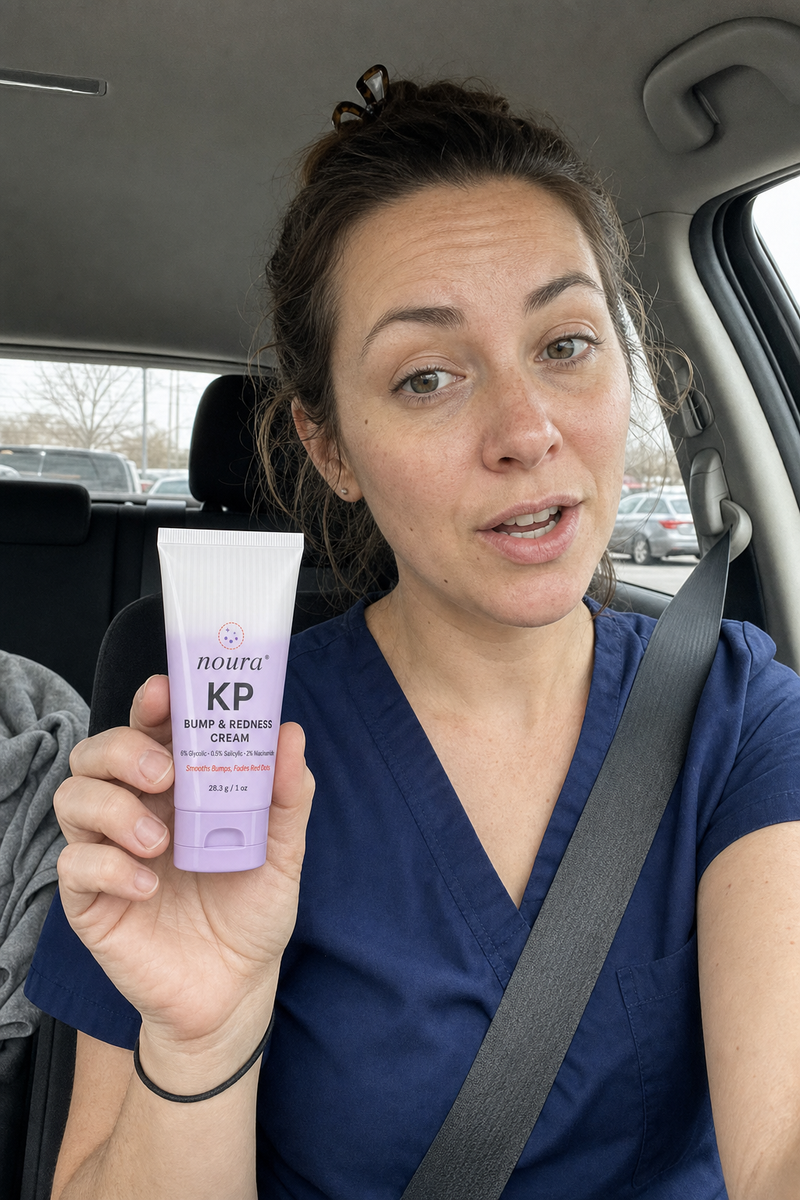 Woman in navy scrubs holding a tube of Noura KP cream in her car