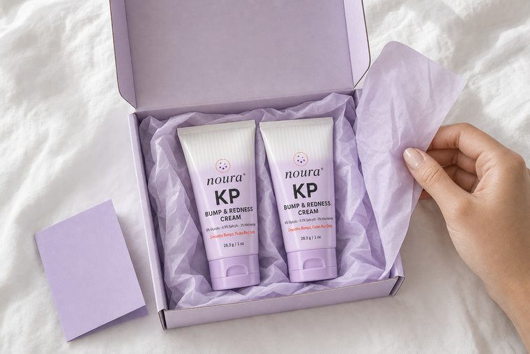 Three tubes of Noura KP Bump & Redness Cream floating on a lavender background